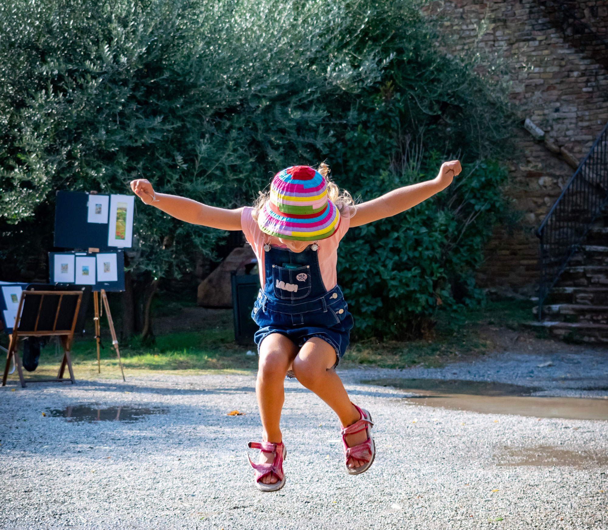 Happy child jumping in air outside. Get clear answers about your child's development through autism testing in Fort Collins, CO.