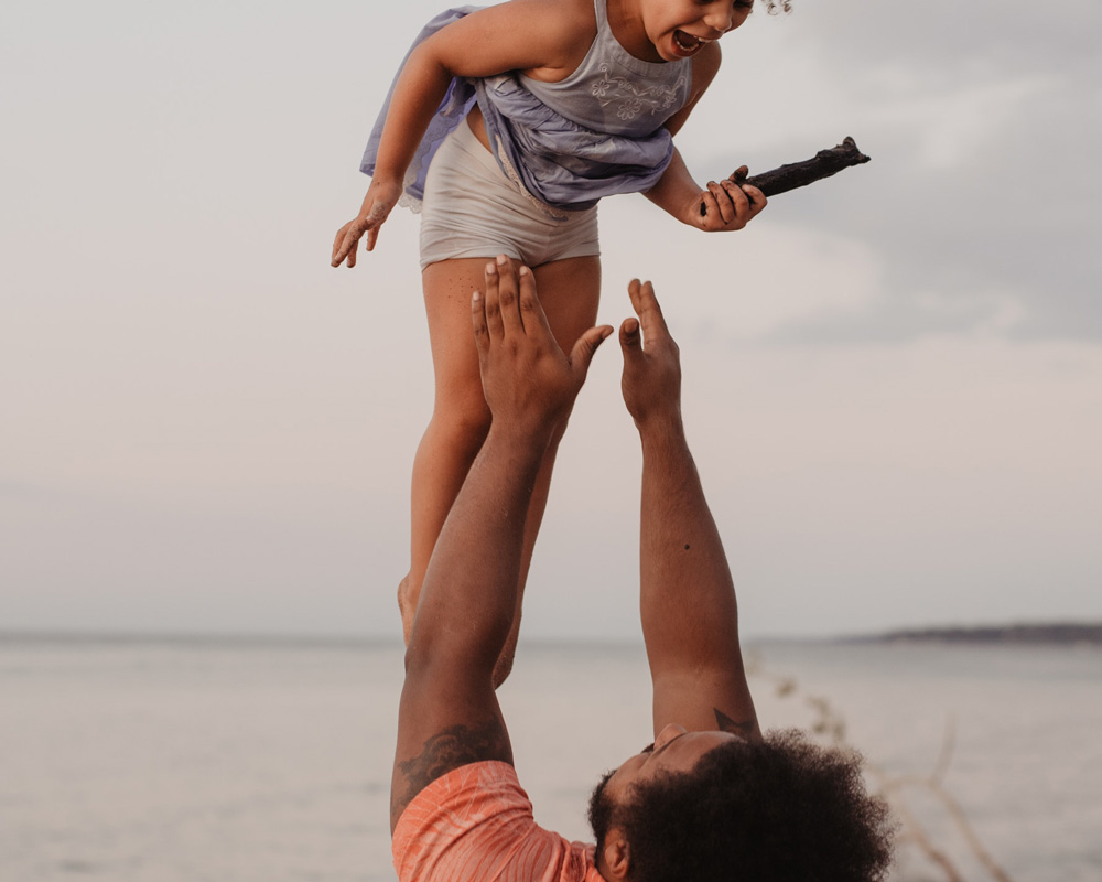 Father throwing child in air. Help your child thrive with comprehensive autism testing for children in Fort Collins, CO.